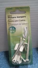 Hillman White Picture Hangers 3PC. (122303) Fs Open. Price: $10.00.