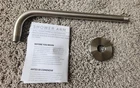 Signature Hardware 12" Brushed Nickel Shower Arm With Round Flange Open. Price: $50.00.