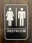 Hillman Unisex Restroom Door Wall Sign W/ Braille - Black & White 6" 9" Used. Price: $5.00.